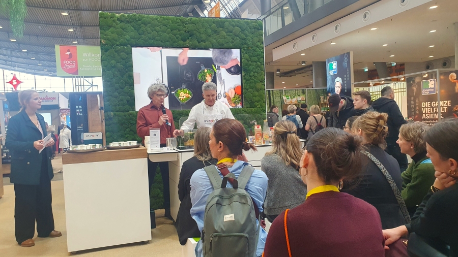 Messestand mit Besuchern während einer Kochshow